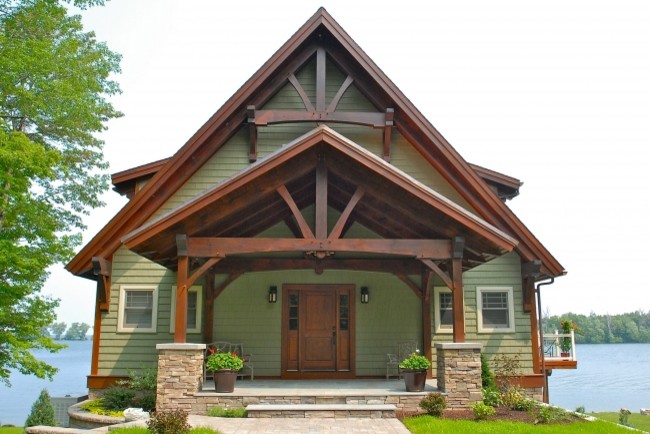 Inspiration for a large arts and crafts three-storey green exterior in Other with vinyl siding.