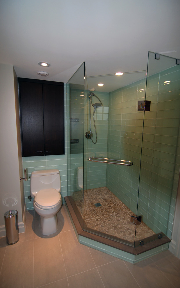 Photo of a mid-sized contemporary 3/4 bathroom in Toronto with a one-piece toilet, glass tile, grey walls, ceramic floors, flat-panel cabinets, dark wood cabinets, a freestanding tub, an alcove shower, blue tile, a drop-in sink, engineered quartz benchtops, beige floor and a hinged shower door.
