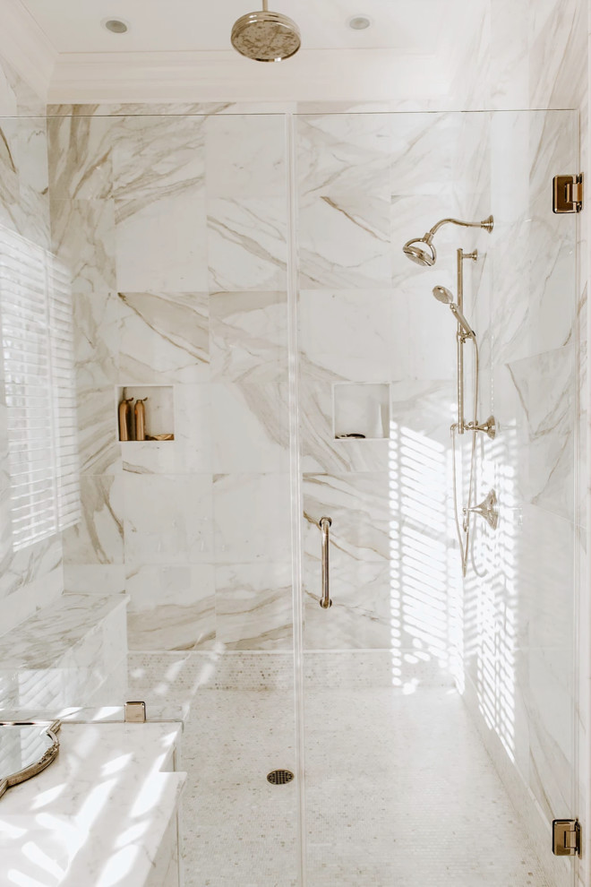 Photo of a large transitional master bathroom in Baltimore with furniture-like cabinets, white cabinets, an undermount tub, an alcove shower, white tile, marble, beige walls, marble floors, an undermount sink, marble benchtops, white floor, a hinged shower door and white benchtops.
