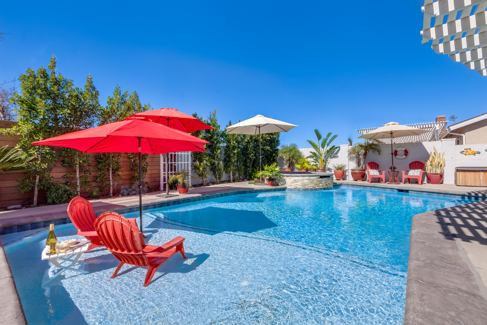 Hot tub - transitional concrete paver and custom-shaped hot tub idea in Orange County