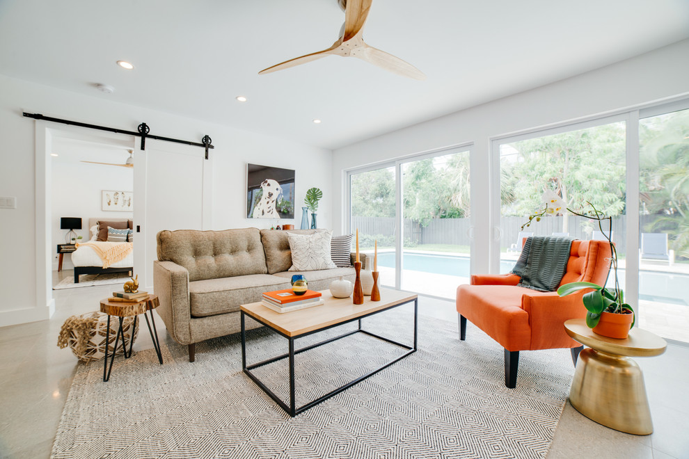 Mid-century modern enclosed beige floor living room photo in Miami with white walls and no fireplace