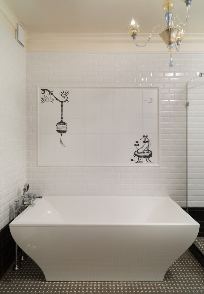 Photo of a traditional bathroom in Moscow with a freestanding tub, white tile and subway tile.
