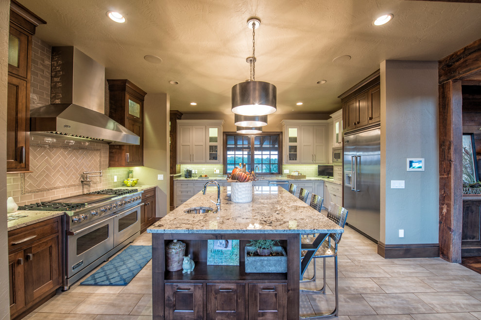 Inspiration for a large timeless u-shaped porcelain tile kitchen remodel with a double-bowl sink, beaded inset cabinets, gray cabinets, granite countertops, beige backsplash, porcelain backsplash, stainless steel appliances and an island