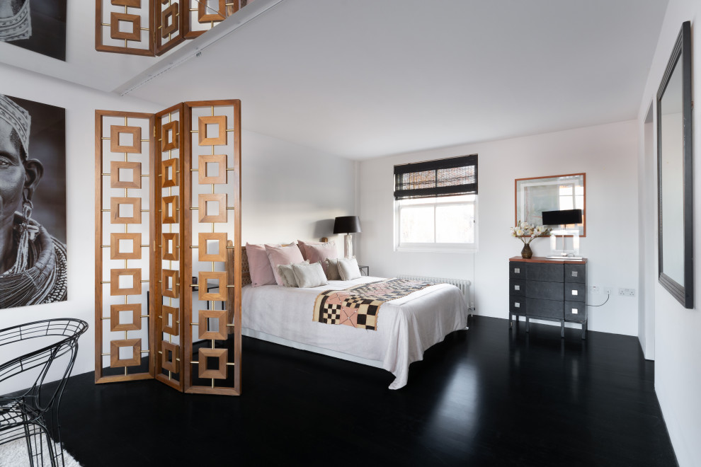 Design ideas for a mid-sized contemporary bedroom in London with white walls, dark hardwood floors and black floor.