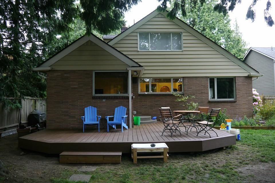 This is an example of a mid-sized traditional backyard patio in Seattle with decking and no cover.