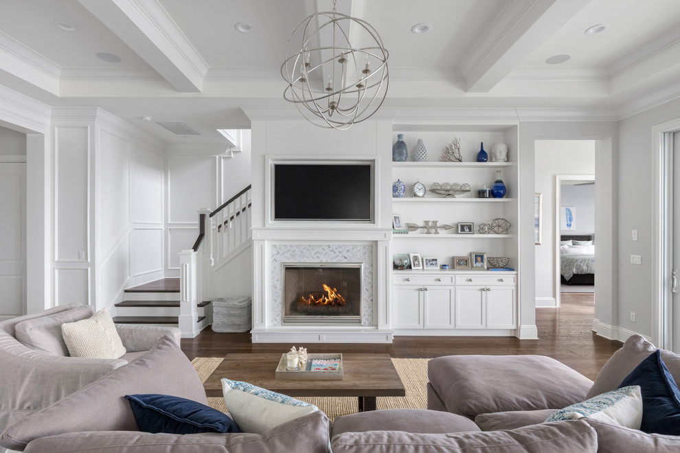 Inspiration for a mid-sized beach style open concept family room in Orlando with grey walls, dark hardwood floors, a standard fireplace, a tile fireplace surround, a built-in media wall and brown floor.