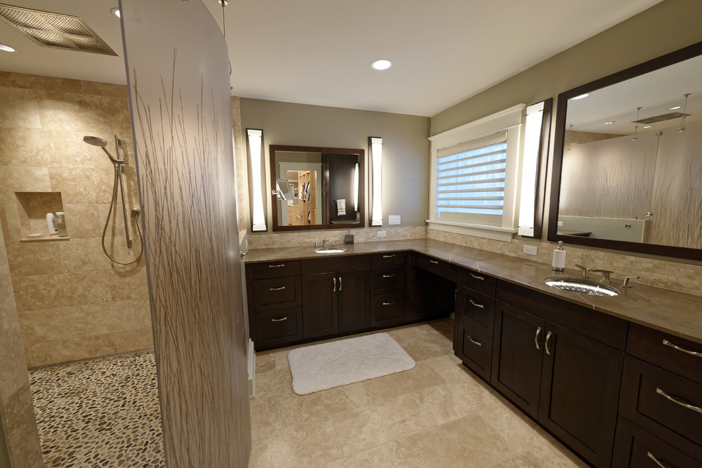 Photo of a large arts and crafts master bathroom in Detroit with shaker cabinets, dark wood cabinets, an open shower, beige tile, beige walls, limestone floors, soapstone benchtops, an undermount sink, a two-piece toilet, limestone, beige floor, an open shower and brown benchtops.