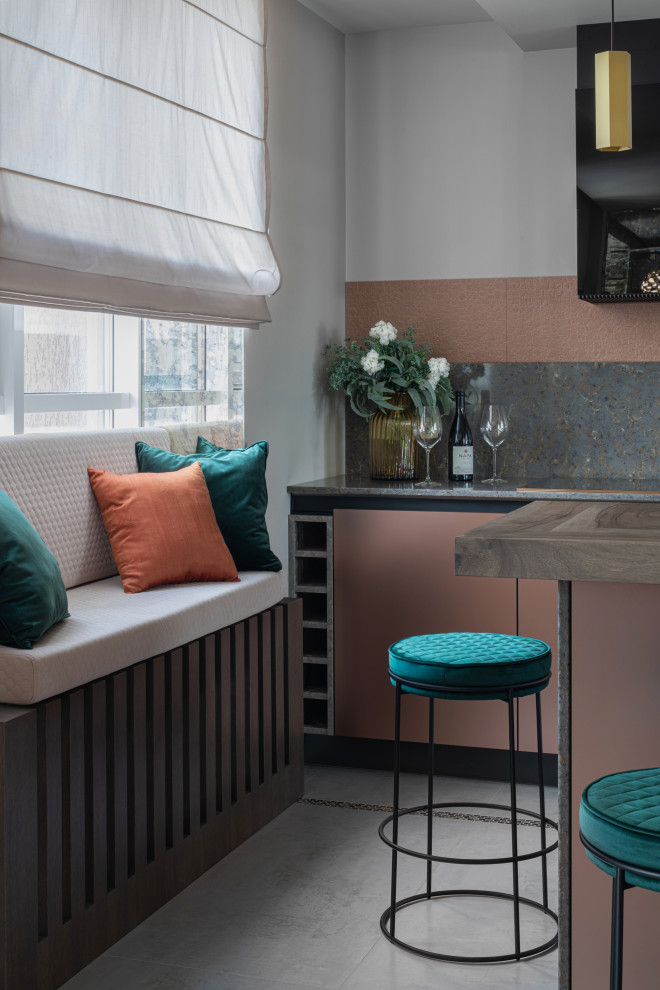 Design ideas for a small contemporary galley kitchen/diner in Yekaterinburg with a submerged sink, flat-panel cabinets, pink cabinets, granite worktops, grey splashback, granite splashback, coloured appliances, porcelain flooring, an island, grey floors, grey worktops and a wallpapered ceiling.