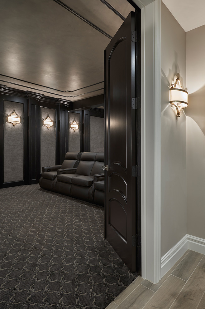 Photo of an expansive transitional enclosed home theatre in Detroit with brown walls, carpet and a projector screen.