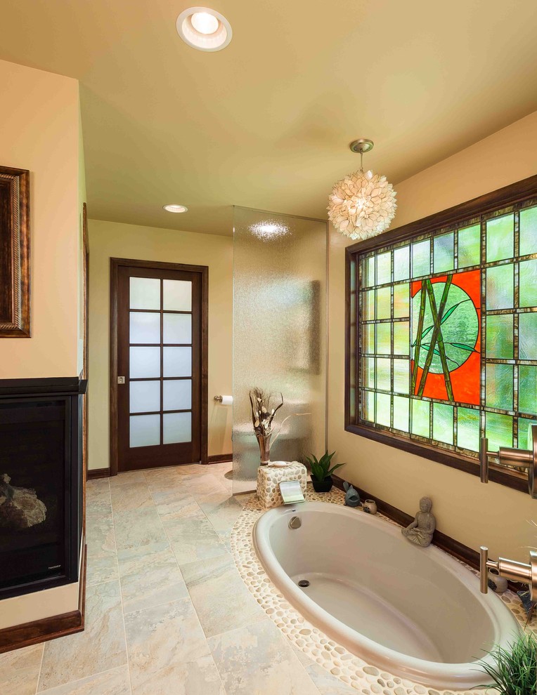 Mid-sized asian master bathroom in Other with a drop-in tub, beige tile and pebble tile.