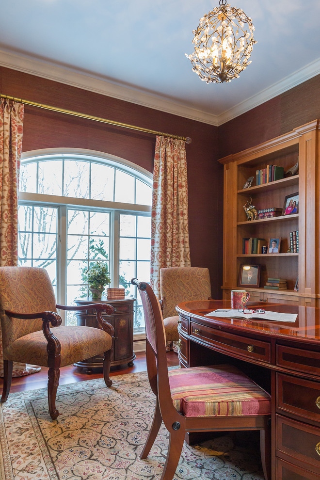 Mid-sized traditional study room in New York with medium hardwood floors, a freestanding desk and brown walls.