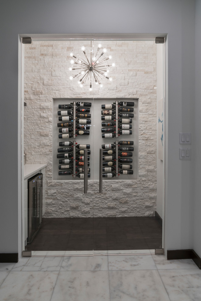 Mid-sized contemporary wine cellar in Orlando with dark hardwood floors, display racks and brown floor.