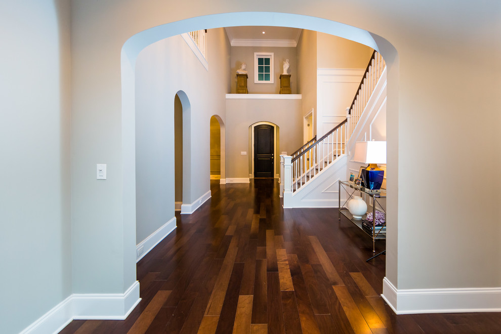 This is an example of a large traditional entryway in Jacksonville with grey walls, medium hardwood floors, a single front door and a brown front door.