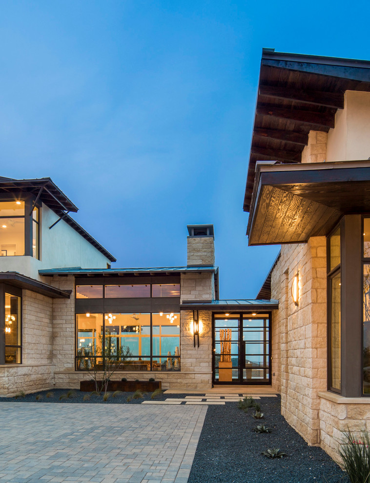 This is an example of a transitional beige exterior in Austin with stone veneer.