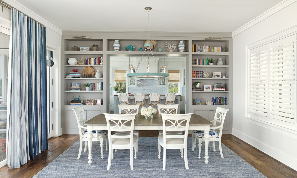 Photo of a beach style separate dining room in Charleston with white walls, dark hardwood floors and brown floor.