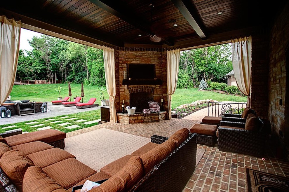 Mid-sized traditional backyard patio in Other with a fire feature, brick pavers and a gazebo/cabana.