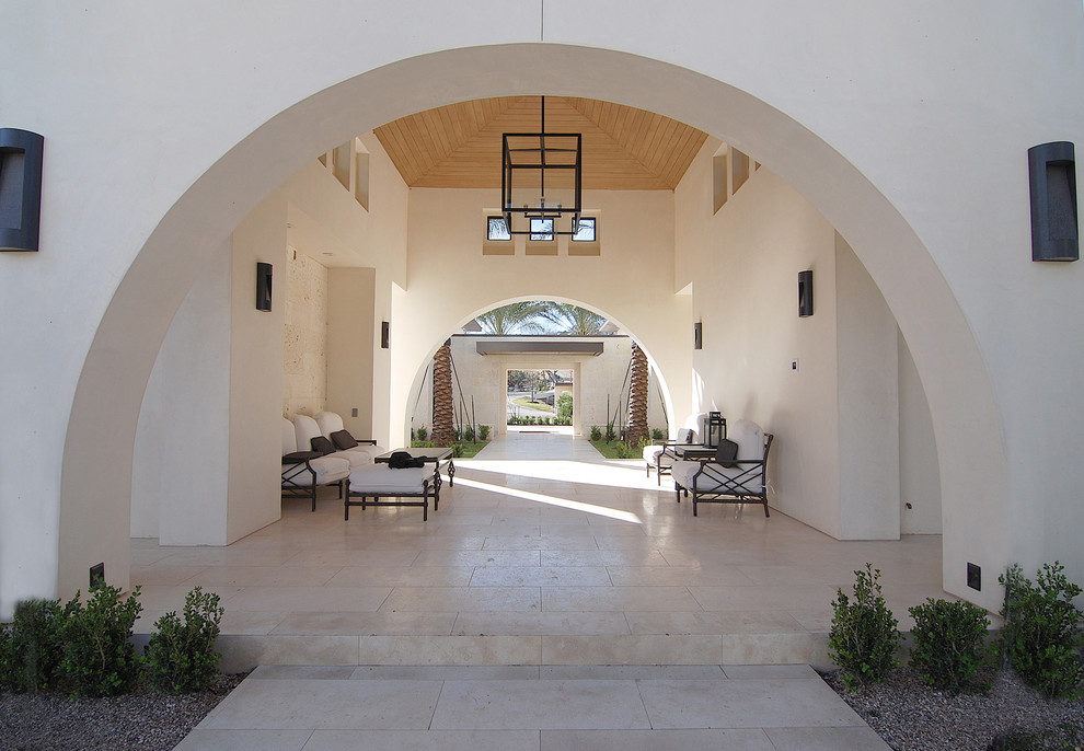 This is an example of a mediterranean patio in Austin with a roof extension.