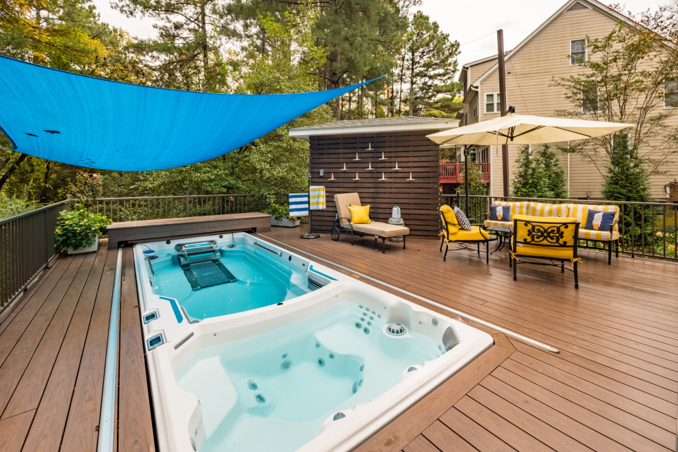 Inspiration for a small timeless side yard rectangular aboveground hot tub remodel in Raleigh with decking