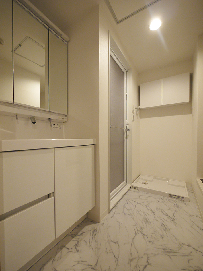 Design ideas for a modern powder room in Tokyo with white cabinets, white walls, ceramic floors, white floor and white benchtops.