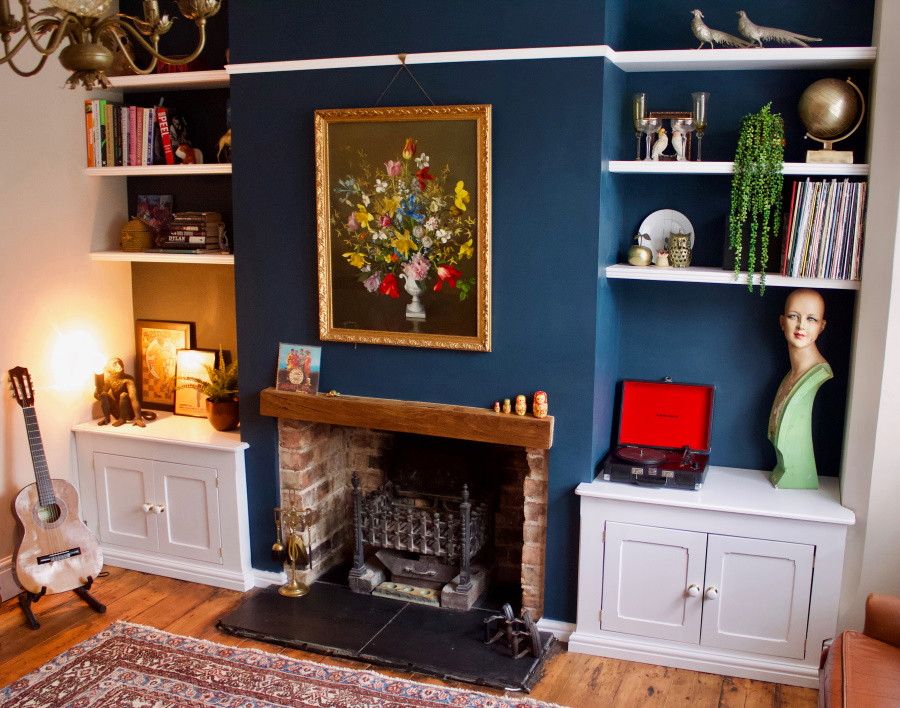 Medium sized victorian enclosed living room in West Midlands with blue walls, medium hardwood flooring, a standard fireplace, a brick fireplace surround and brown floors.