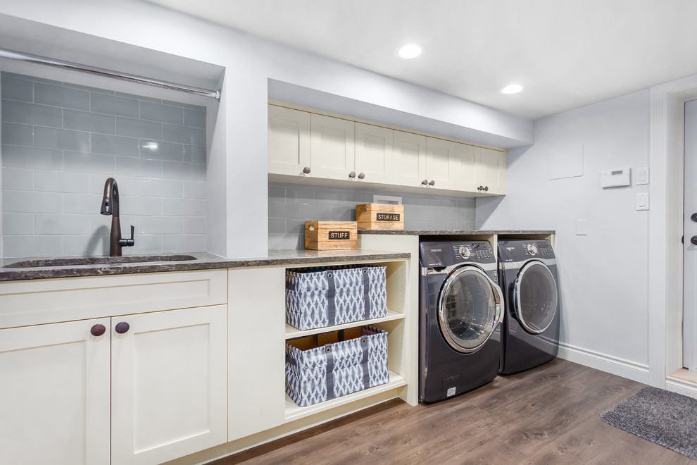 Inspiration for a mid-sized modern laundry room in Vancouver with grey walls and vinyl floors.