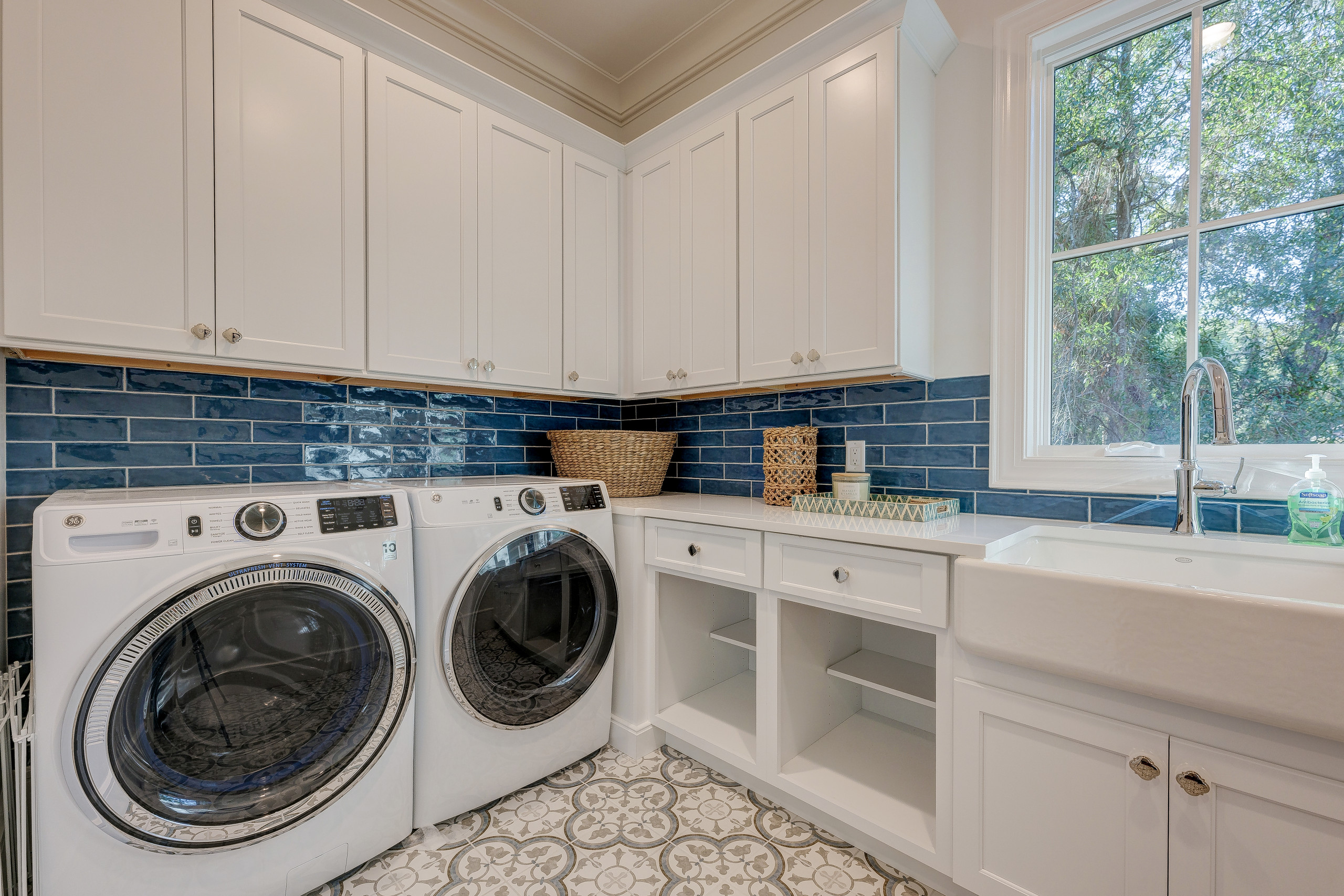 Bold and bright laundry room with farm sink