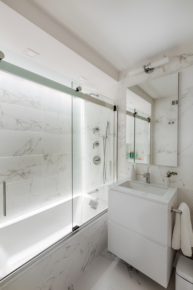 Medium sized contemporary family bathroom in New York with flat-panel cabinets, white cabinets, a built-in bath, a one-piece toilet, white tiles, porcelain tiles, white walls, porcelain flooring, a built-in sink, recycled glass worktops, white floors, white worktops, a wall niche, a single sink, a floating vanity unit and a vaulted ceiling.
