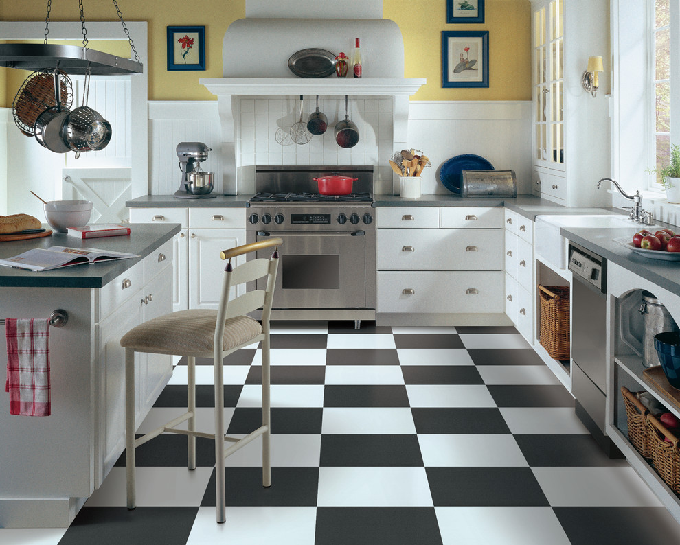 Design ideas for a mid-sized country l-shaped separate kitchen in Other with a farmhouse sink, flat-panel cabinets, white cabinets, solid surface benchtops, white splashback, timber splashback, stainless steel appliances, porcelain floors, with island and black floor.