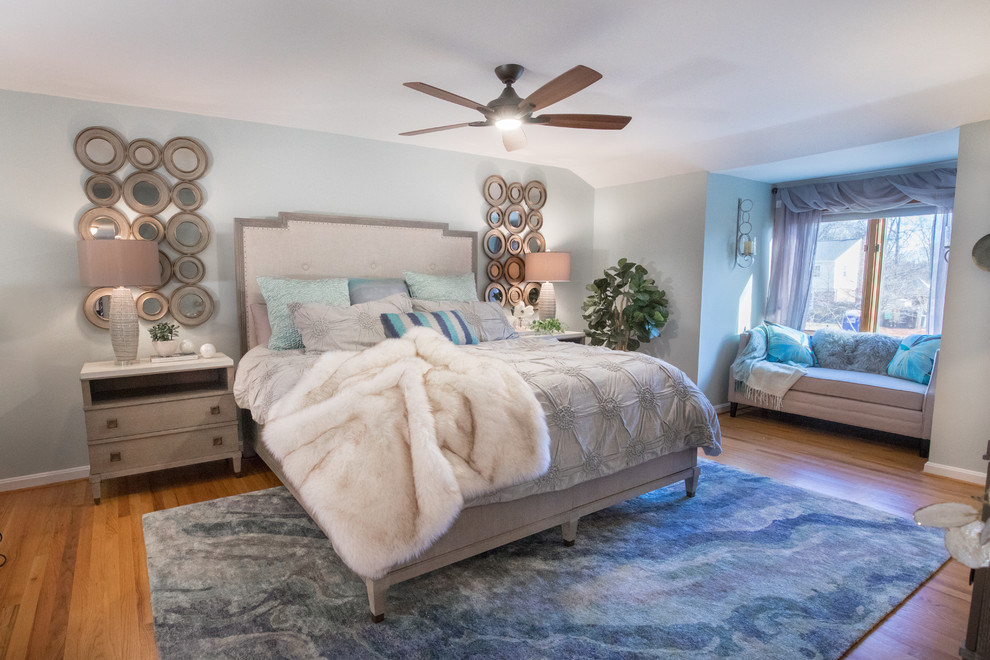 Inspiration for a large beach style master bedroom in Philadelphia with medium hardwood floors, brown floor and blue walls.