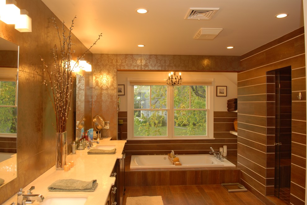 Inspiration for a large traditional master bathroom in New York with an undermount sink, raised-panel cabinets, dark wood cabinets, marble benchtops, a drop-in tub, an alcove shower, a two-piece toilet, brown tile, porcelain tile and porcelain floors.
