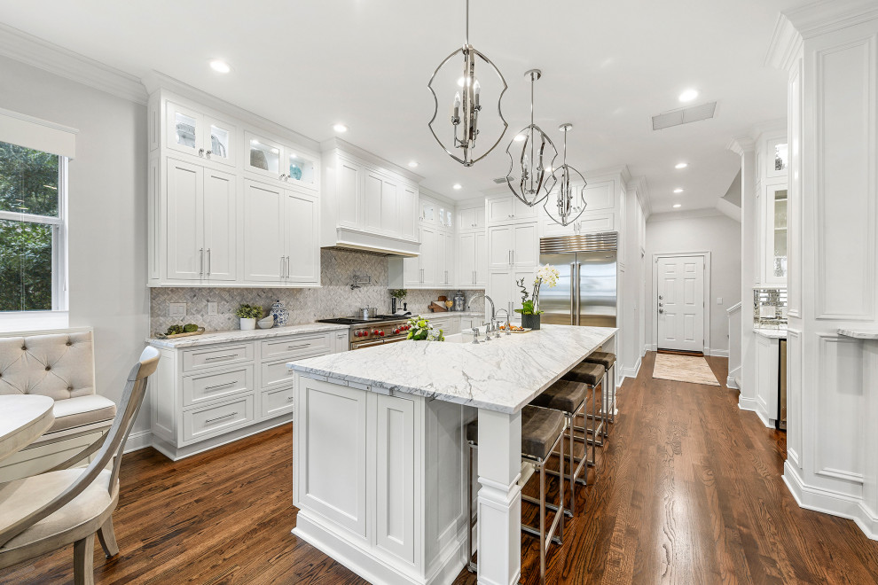 Inspiration for a transitional l-shaped medium tone wood floor and brown floor eat-in kitchen remodel in Jacksonville with a farmhouse sink, beaded inset cabinets, white cabinets, marble countertops, gray backsplash, stainless steel appliances, an island and gray countertops