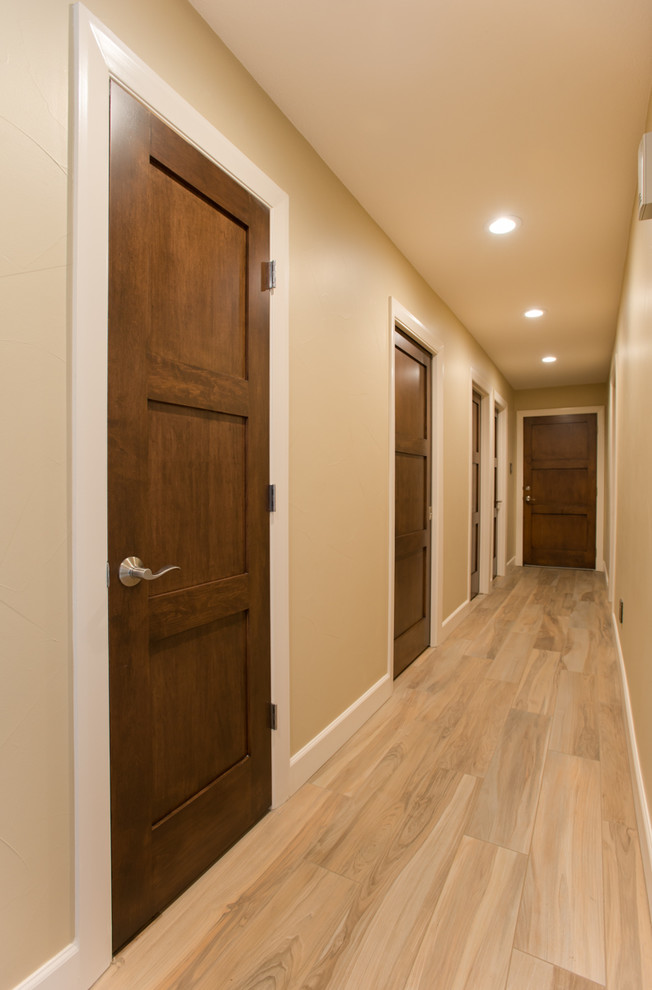 Inspiration for a large contemporary hallway in Dallas with beige walls, porcelain floors and beige floor.