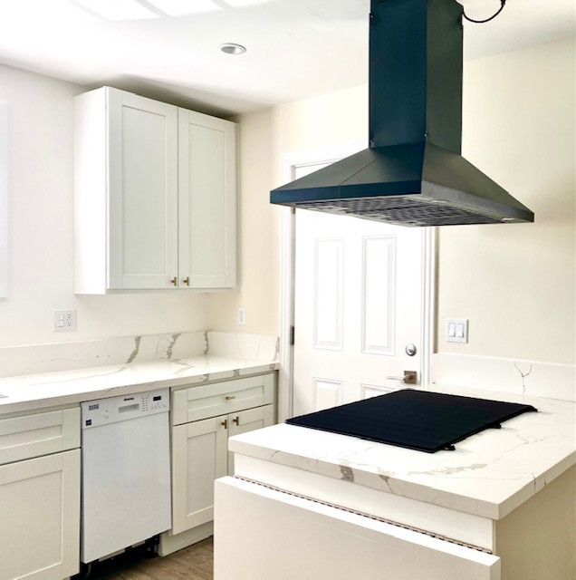 Small galley eat-in kitchen in Los Angeles with an undermount sink, shaker cabinets, white cabinets, quartz benchtops, white splashback, engineered quartz splashback, stainless steel appliances, vinyl floors, with island, brown floor and white benchtop.