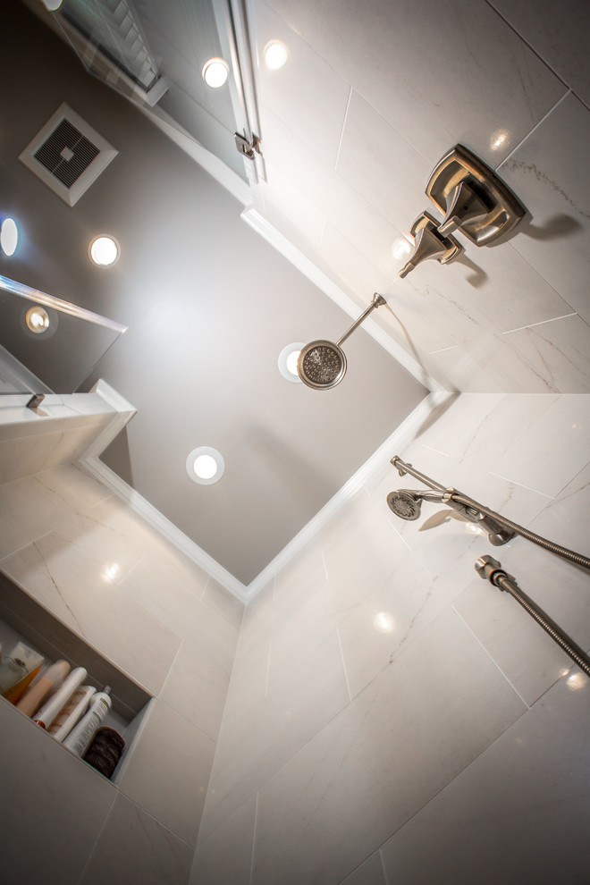 Bathroom - large transitional gray tile and porcelain tile porcelain tile bathroom idea in DC Metro with an undermount sink, flat-panel cabinets, white cabinets, quartz countertops, a two-piece toilet and gray walls