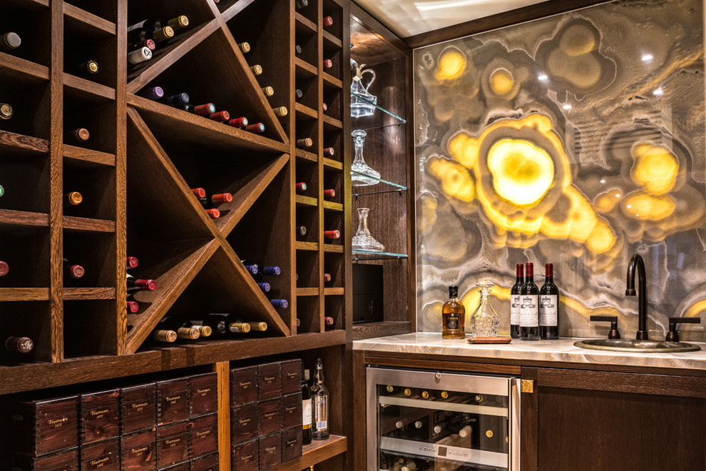This is an example of a transitional wine cellar in London with storage racks.