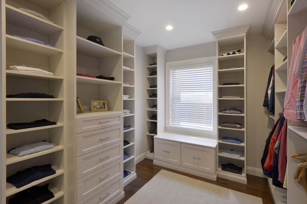 Inspiration for a large contemporary gender-neutral walk-in wardrobe in New York with shaker cabinets, white cabinets and dark hardwood floors.