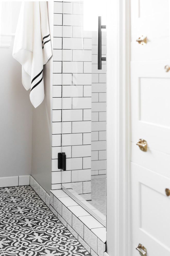 Design ideas for a mid-sized modern 3/4 bathroom in Seattle with an alcove shower, a two-piece toilet, white tile, subway tile, grey walls, cement tiles, a pedestal sink, multi-coloured floor and a hinged shower door.