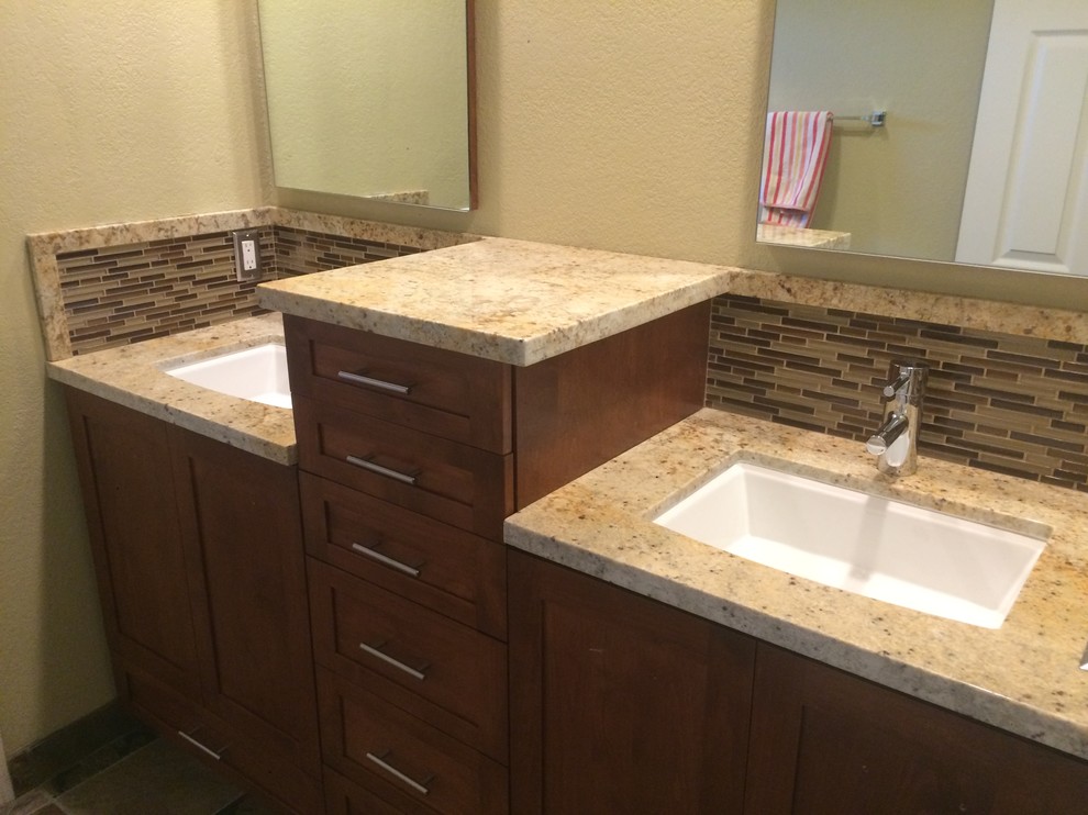 Photo of a mid-sized transitional master bathroom in San Diego with shaker cabinets, dark wood cabinets, slate floors, a trough sink and granite benchtops.