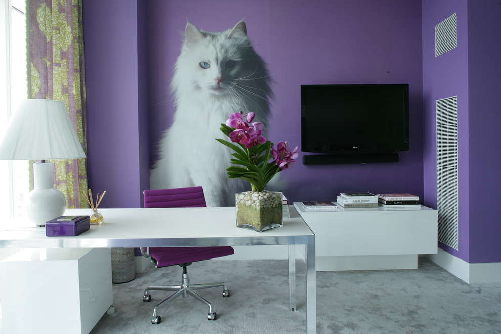 This is an example of a contemporary home office in New York with purple walls, a freestanding desk and grey floor.