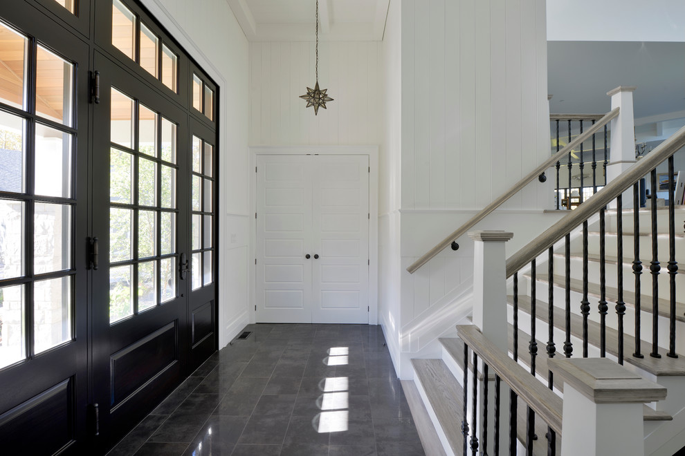 Mid-sized transitional foyer in Toronto with white walls, porcelain floors, a single front door and a black front door.