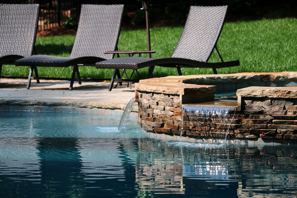 Inspiration for a large rustic backyard concrete paver and custom-shaped natural hot tub remodel in Raleigh