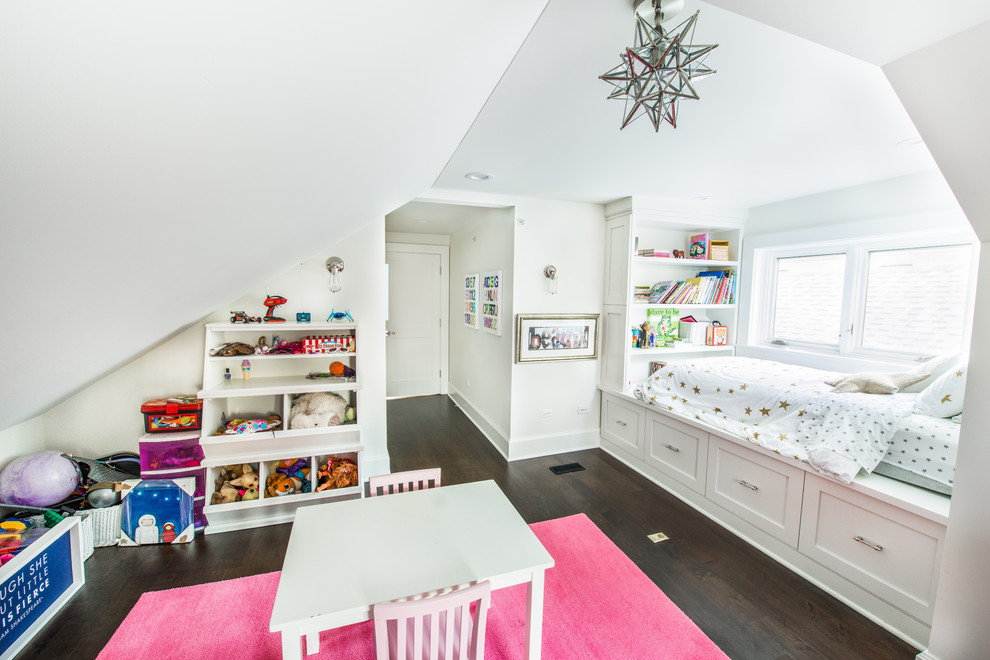 Photo of a transitional kids' playroom for kids 4-10 years old and girls in Chicago with grey walls and dark hardwood floors.