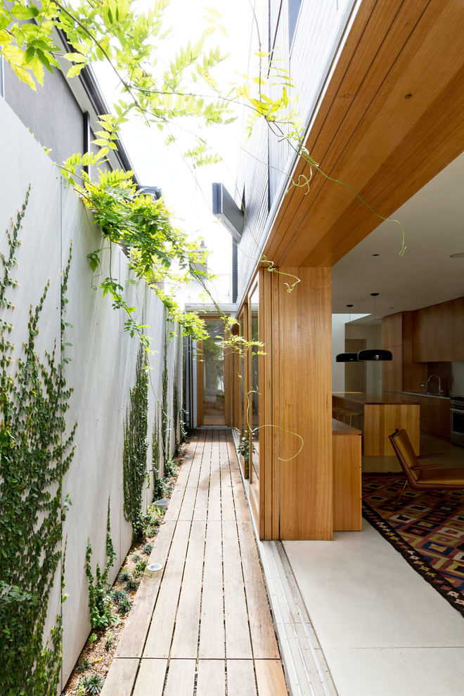 Photo of a modern side yard deck in Sydney with no cover.