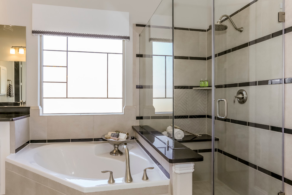 Photo of a large transitional master bathroom in Houston with recessed-panel cabinets, white cabinets, a corner tub, a corner shower, black and white tile, porcelain tile, grey walls, porcelain floors, an undermount sink and solid surface benchtops.