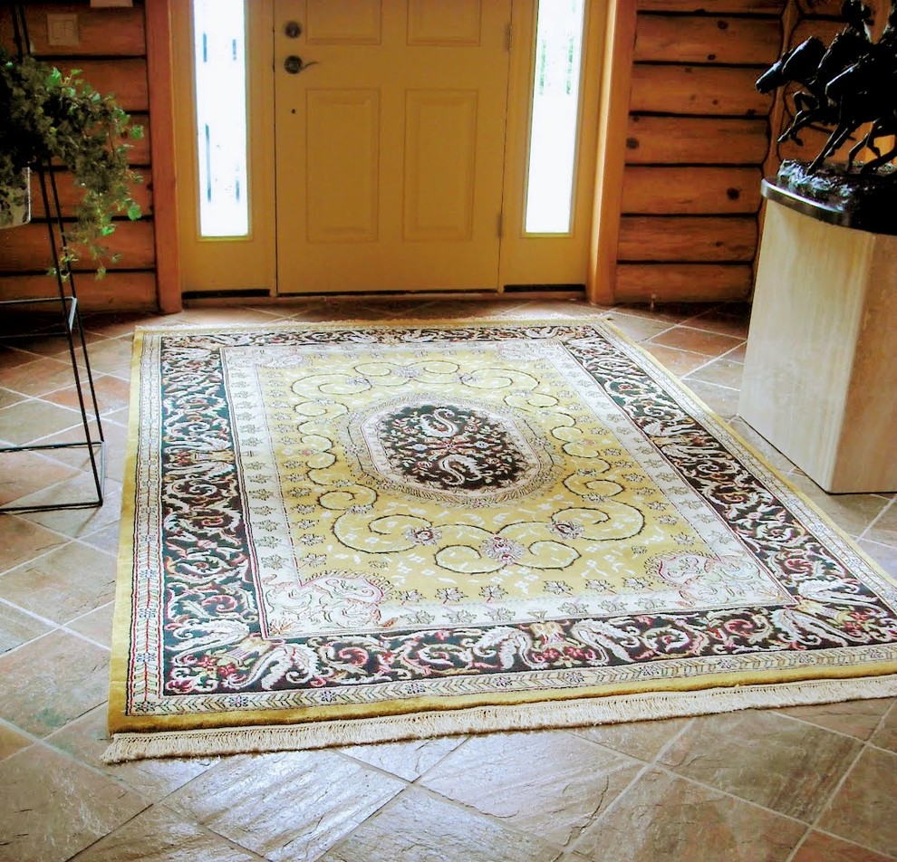 Inspiration for a mid-sized slate floor and brown floor front door remodel with a yellow front door