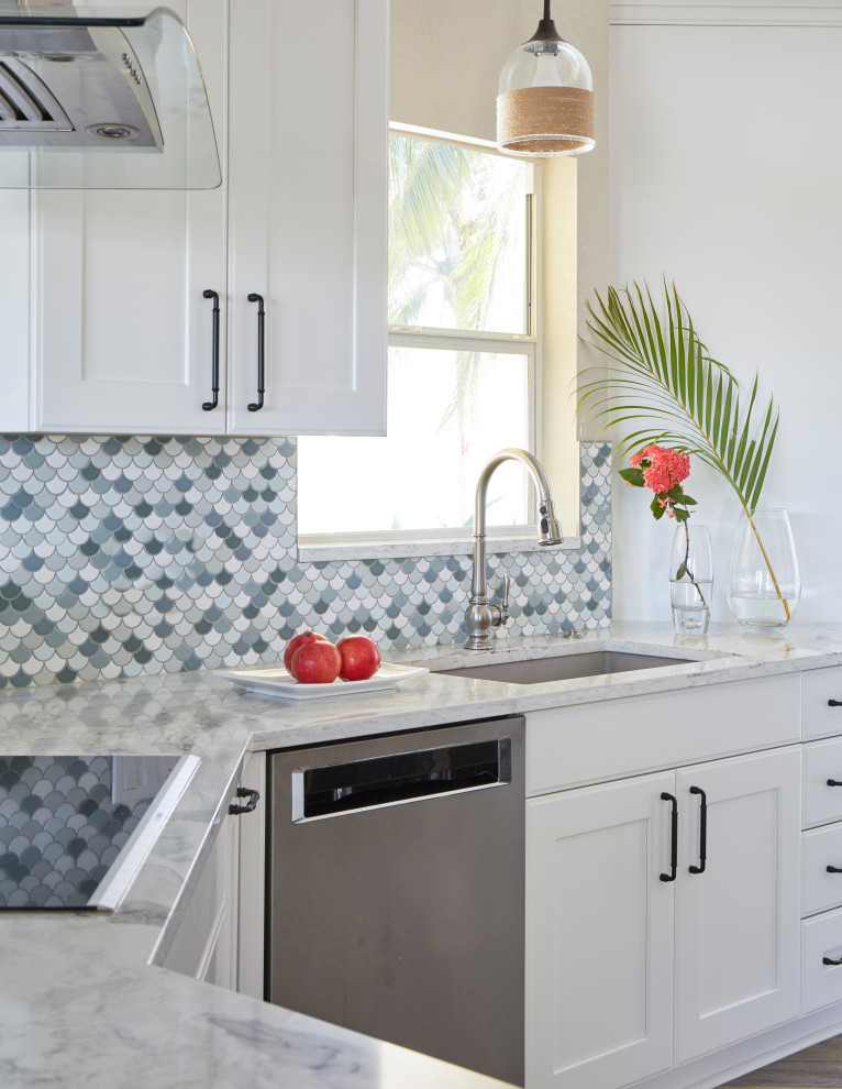 Inspiration for a mid-sized beach style open plan kitchen in Other with an undermount sink, recessed-panel cabinets, white cabinets, quartz benchtops, blue splashback, ceramic splashback, stainless steel appliances, vinyl floors, multi-coloured floor, multi-coloured benchtop and vaulted.