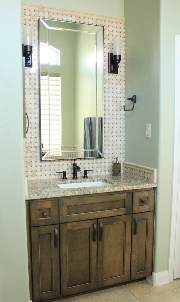 Photo of a large traditional master bathroom in Austin with shaker cabinets, dark wood cabinets, a freestanding tub, a corner shower, beige tile, porcelain tile, green walls, porcelain floors, an undermount sink and granite benchtops.