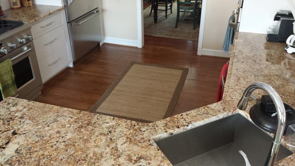 Example of a small transitional u-shaped medium tone wood floor enclosed kitchen design in Baltimore