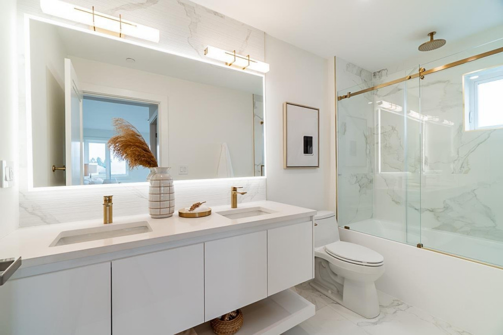 Small transitional master multicolored tile and ceramic tile ceramic tile, white floor and double-sink alcove bathtub photo in Vancouver with flat-panel cabinets, white cabinets, a one-piece toilet, white walls, an undermount sink, quartzite countertops, white countertops and a floating vanity