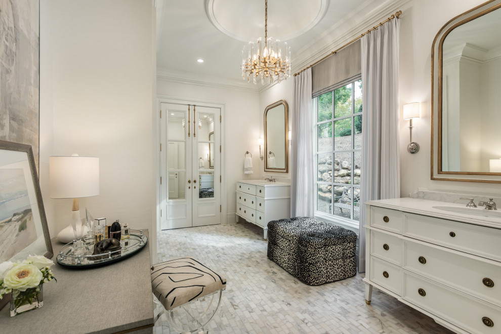 Example of a large transitional master white tile and marble tile marble floor and gray floor bathroom design with furniture-like cabinets, white cabinets, a two-piece toilet, white walls, an undermount sink, marble countertops and white countertops